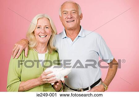 Couple with piggy bank View Large Photo Image Stock Image - Couple with piggy bank. Fotosearch