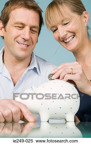 Couple with piggy bank View Large Photo Image Stock Photography - Couple with piggy bank. Fotosearch