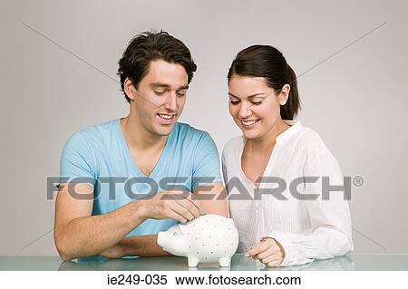 Couple with piggy bank View Large Photo Image Stock Photography - Couple with piggy bank. Fotosearch