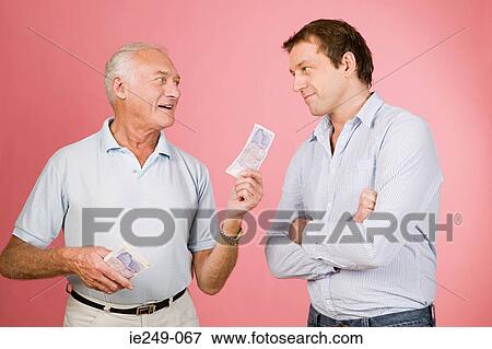 Man handing banknote to son View Large Photo Image Stock Photo - Man handing banknote to son. Fotosearch