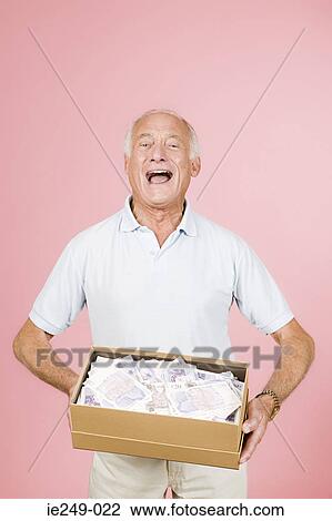 Man holding a box of banknotes View Large Photo Image Stock Image - Man holding a box of banknotes. Fotosearch