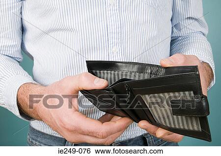 Man holding empty wallet View Large Photo Image Stock Photograph - Man holding empty wallet. Fotosearch