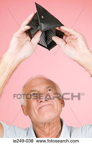 Man looking in empty wallet View Large Photo Image Stock Photo - Man looking in empty wallet. Fotosearch