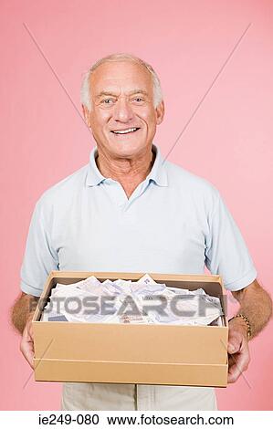 Man with box of money View Large Photo Image Stock Image - Man with box of money. Fotosearch