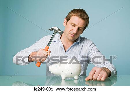 Man with hammer and piggy bank View Large Photo Image Stock Photography - Man with hammer and piggy bank. Fotosearch