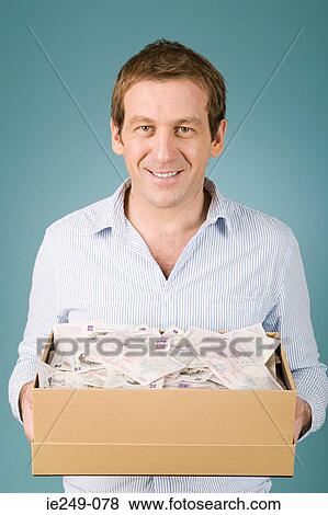 Man with shoebox of money View Large Photo Image Stock Photo - Man with shoebox of money. Fotosearch