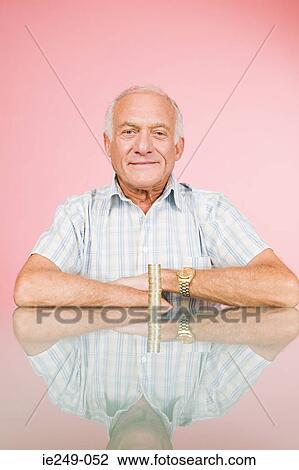 Man with stack of coins View Large Photo Image Stock Image - Man with stack of coins. Fotosearch