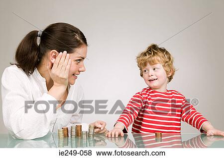 Woman and boy with coins View Large Photo Image Stock Photo - Woman and boy with coins. Fotosearch
