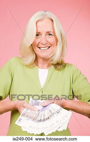 Woman holding banknotes View Large Photo Image Picture - Woman holding banknotes. Fotosearch