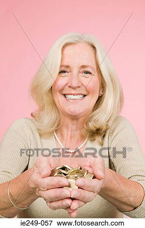 Woman holding pound coins View Large Photo Image Stock Photo - Woman holding pound coins. Fotosearch