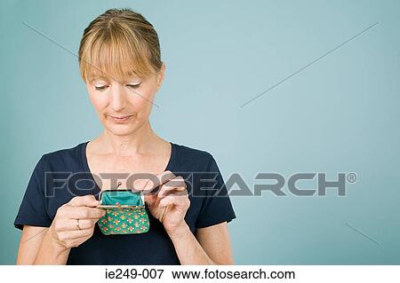 Woman looking in purse View Large Photo Image Stock Photo - Woman looking in purse. Fotosearch