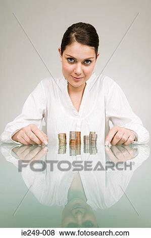 Woman with stacks of coins View Large Photo Image Stock Photo - Woman with stacks of coins. Fotosearch