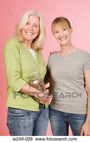 Stock Photo - Women with jar of coins. Fotosearch
