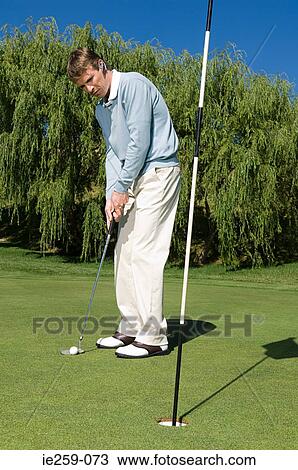 A businessman playing golf View Large Photo Image Stock Image - A businessman playing golf. Fotosearch