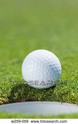 A golf ball and hole View Large Photo Image Stock Photo - A golf ball and hole. Fotosearch