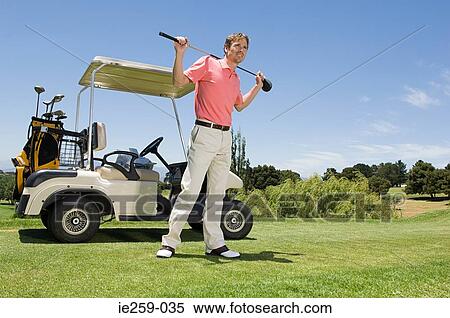 A golfer holding a golf club View Large Photo Image Stock Photography - A golfer holding a golf club. Fotosearch
