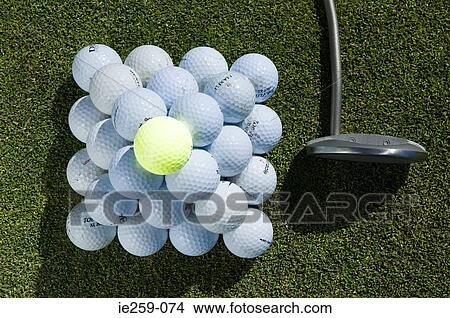 A stack of golf balls and a golf club View Large Photo Image Picture - A stack of golf balls and a golf club. Fotosearch