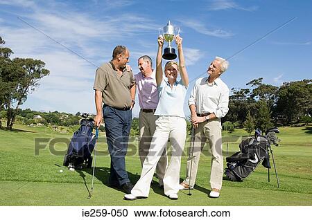 A woman holding a trophy View Large Photo Image Stock Image - A woman holding a trophy. Fotosearch