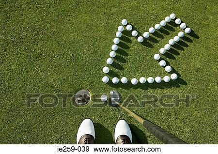Stock Photo - An arrow pointing to a hole on a golf grees. Fotosearch