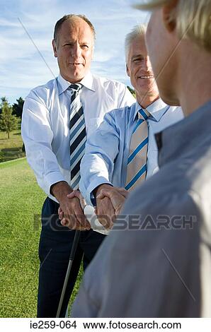 Picture - Businesspeople shaking hands . Fotosearch