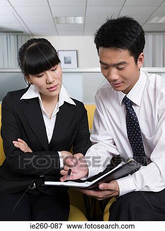 Stock Photo - Business colleagues with file. Fotosearch