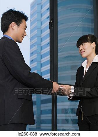 Stock Photo - Business people with business card. Fotosearch