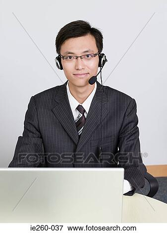 Businessman wearing headset View Large Photo Image Stock Photo - Businessman wearing headset. Fotosearch