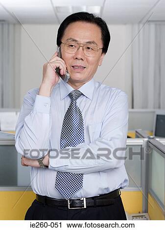 Stock Image - Businessman with cellphone. Fotosearch