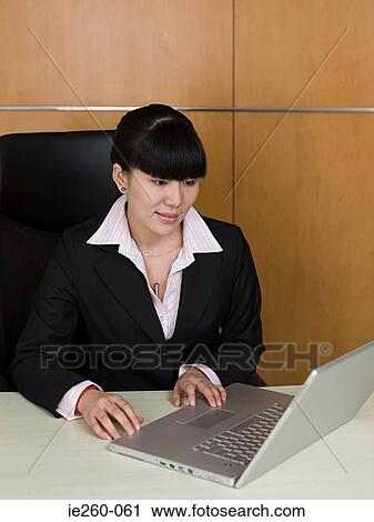 Businesswoman working on laptop View Large Photo Image Stock Image - Businesswoman working on laptop. Fotosearch