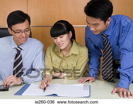 Stock Photograph - Colleagues working together. Fotosearch