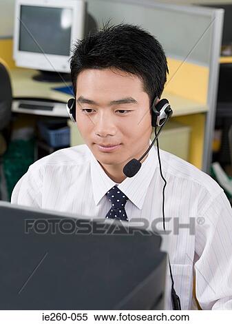Office worker wearing headset View Large Photo Image Stock Photography - Office worker wearing headset. Fotosearch