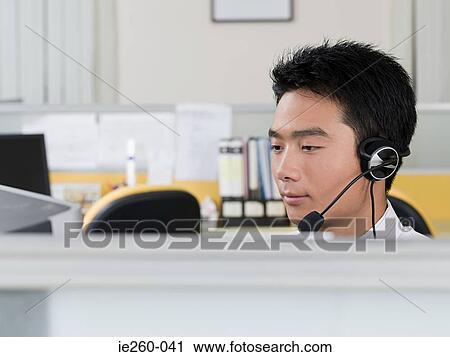 Stock Image - Office worker with headset. Fotosearch