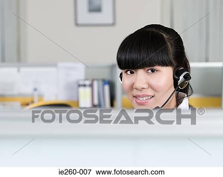 Stock Photo - Woman wearing headset. Fotosearch