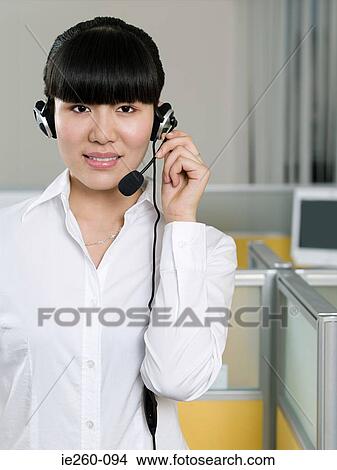 Woman wearing telephone headset View Large Photo Image Picture - Woman wearing telephone headset. Fotosearch