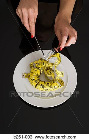 Eating a tape measure View Large Photo Image Stock Image - Eating a tape measure. Fotosearch