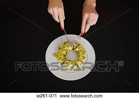 Eating a tape measure View Large Photo Image Stock Image - Eating a tape measure. Fotosearch