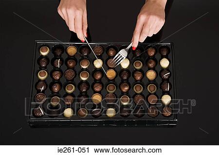 Woman eating chocolates View Large Photo Image Stock Image - Woman eating chocolates. Fotosearch
