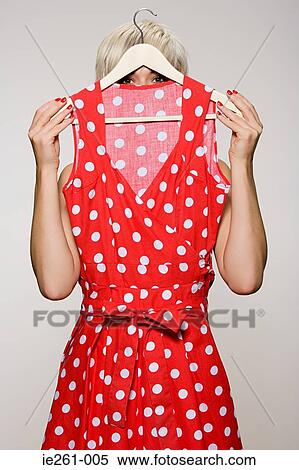 Stock Photography - Woman holding a dress. Fotosearch