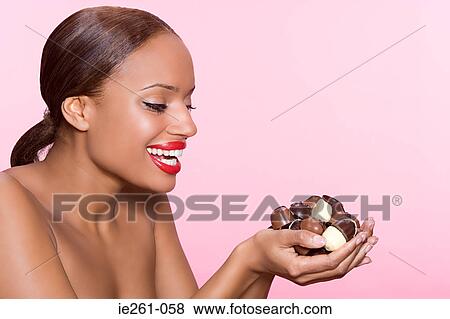 Woman holding chocolates View Large Photo Image Stock Photo - Woman holding chocolates. Fotosearch