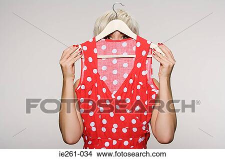Woman holding dress View Large Photo Image Picture - Woman holding dress. Fotosearch