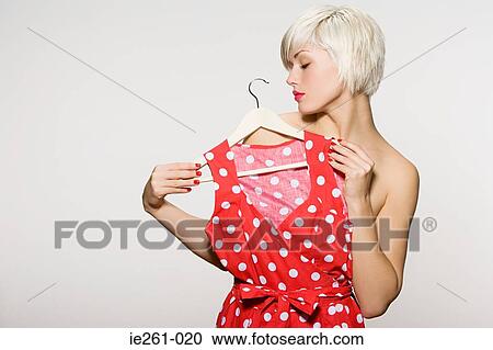 Woman holding dress View Large Photo Image Stock Image - Woman holding dress. Fotosearch