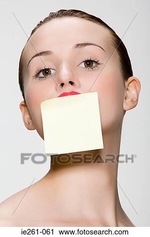 Woman with adhesive note on her mouth View Large Photo Image Stock Image - Woman with adhesive note on her mouth. Fotosearch