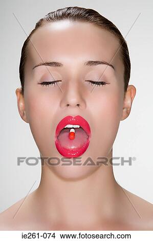 Woman with pill on her tongue View Large Photo Image Picture - Woman with pill on her tongue. Fotosearch
