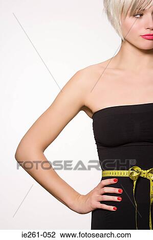 Woman with tape measure around her waist View Large Photo Image Stock Image - Woman with tape measure around her waist. Fotosearch