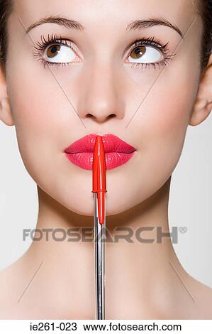 Young woman with a pen View Large Photo Image Stock Image - Young woman with a pen. Fotosearch