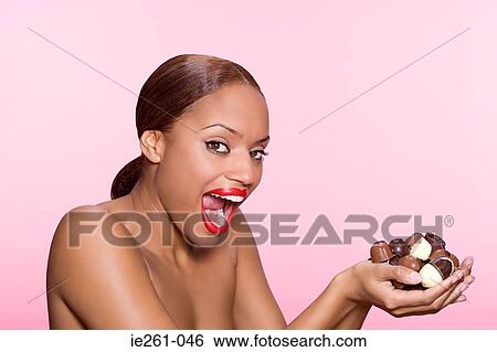 Young woman with chocolates View Large Photo Image Stock Photograph - Young woman with chocolates. Fotosearch