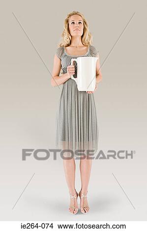Picture - Young woman holding jug. Fotosearch