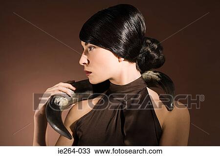 Young woman with animal horn View Large Photo Image Stock Image - Young woman with animal horn. Fotosearch