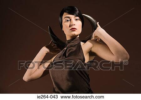 Young woman with animal horn View Large Photo Image Stock Image - Young woman with animal horn. Fotosearch