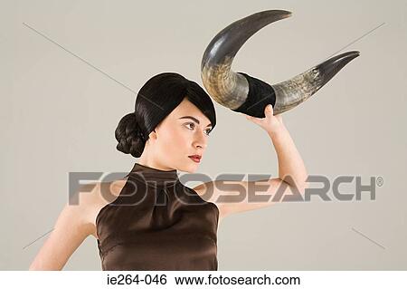 Young woman with animal horn View Large Photo Image Stock Photograph - Young woman with animal horn. Fotosearch
